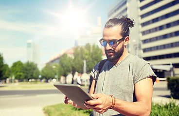 Image showing man traveling with backpack and tablet pc in city