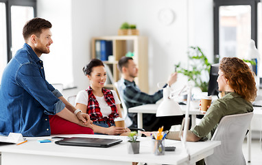 Image showing creative team drinking coffee at office