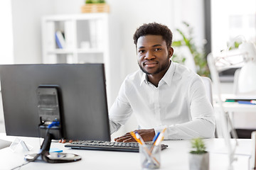 Image showing african businessman with computer at office