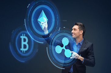 Image showing businessman with cryptocurrency holograms