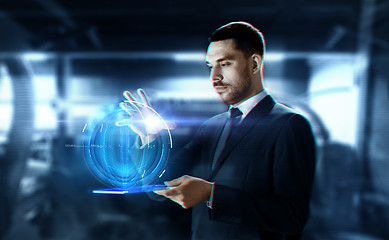 Image showing businessman with transparent tablet and hologram