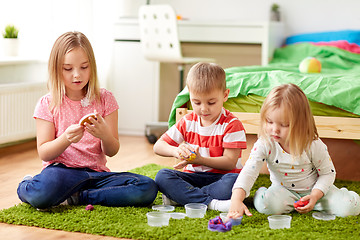 Image showing kids with modelling clay or slimes at home