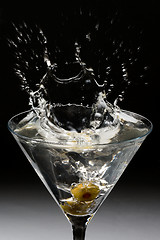 Image showing Dropping olives into a martini
