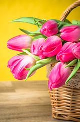 Image showing Beautiful bouquet of pink tulips in a wicker basket