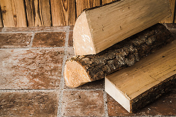 Image showing Logs of firewood on the floor, close-up