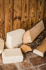 Image showing Wood briquette and firewood, close-up