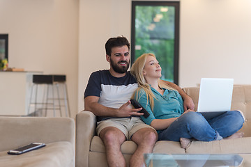 Image showing young happy couple relaxes in the living room