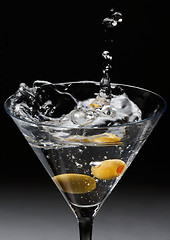 Image showing Dropping olives into a Martini