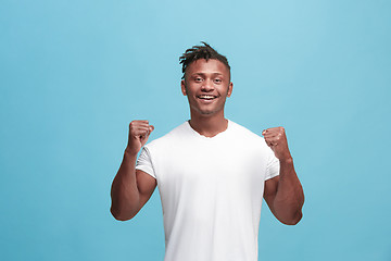 Image showing Winning success afro-american man happy ecstatic celebrating being a winner. Dynamic energetic image of male model