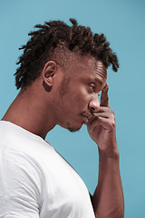 Image showing Let me think. Doubtful pensive Afro-American man with thoughtful expression making choice against blue background