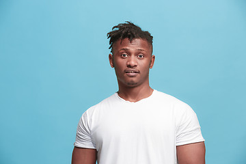 Image showing The surprised business Afro-American man standing and looking pink background.