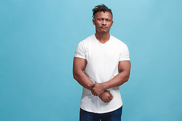 Image showing Beautiful afro-american man looking suprised and bewildered isolated on pink