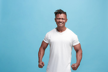 Image showing The young emotional angry afro man screaming on blue studio background