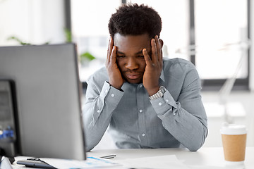 Image showing stressed businessman with papers at office