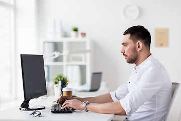 Image showing businessman typing on computer keyboard at office