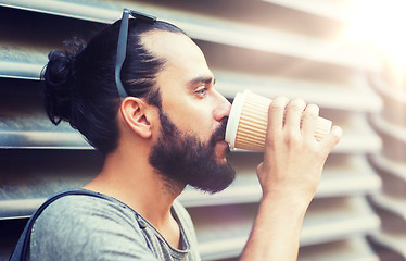 Image showing man drinking coffee from paper cup on street