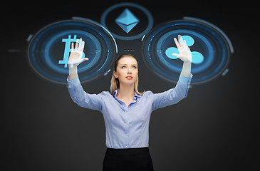Image showing businesswoman with cryptocurrency holograms