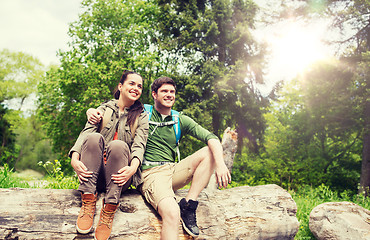 Image showing smiling couple with backpacks in nature