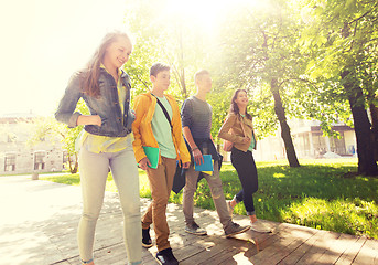 Image showing group of happy teenage students walking outdoors