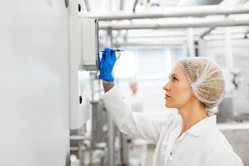 Image showing woman programming computer at ice cream factory