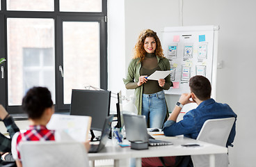 Image showing creative woman showing user interface at office