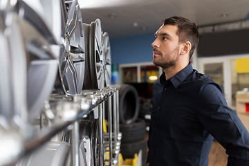 Image showing male customer choosing wheel rims at car service