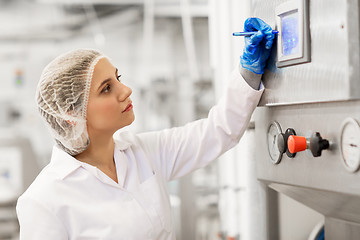 Image showing woman programming computer at ice cream factory