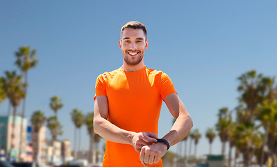 Image showing man with fitness tracker training outdoors