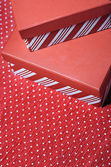 Image showing Christmas gift boxes on a red wrapping paper