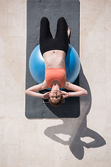 Image showing woman doing exercise with pilates ball top view
