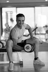 Image showing handsome man working out with dumbbells