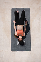 Image showing woman doing morning yoga exercises top view