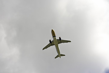 Image showing Airplane flies against a background of white cloud