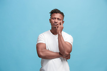 Image showing Young serious thoughtful Afro-American businessman. Doubt concept.