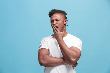 Image showing Beautiful bored faro-american man bored isolated on blue background