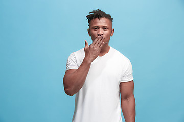 Image showing Portrait of attractive Afro-American man with air kiss isolated over blue background