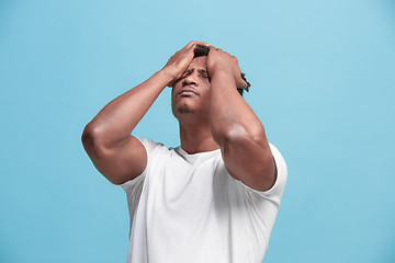 Image showing African American Man having headache. Isolated over blue background.