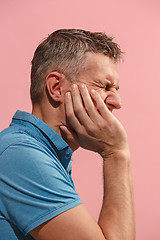 Image showing Young man is having toothache.