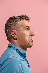 Image showing Beautiful man looking suprised and bewildered isolated on pink