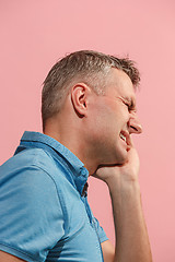 Image showing Young man is having toothache.