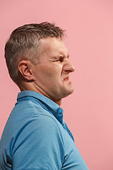 Image showing Let me think. Doubtful pensive man with thoughtful expression making choice against pink background