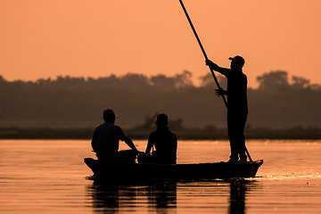 Image showing Men in a boat on a river silhouette