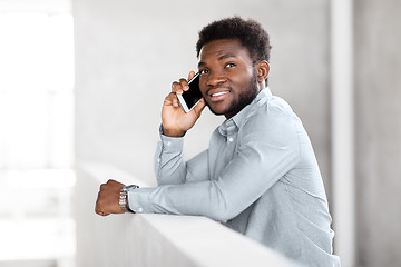 Image showing businessman calling on smartphone at office