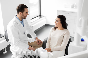 Image showing dentist talking to female patient at dental clinic