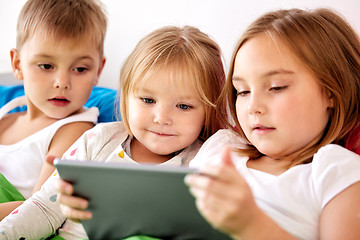 Image showing little kids with tablet pc in bed at home