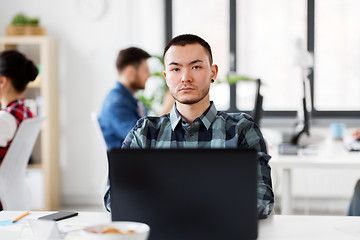 Image showing creative man with laptop working at office