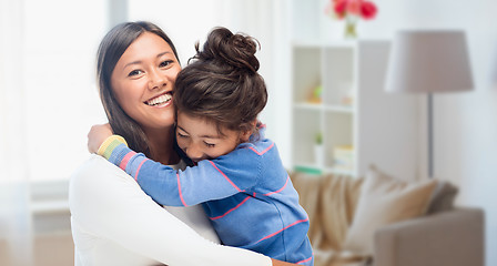 Image showing happy mother and daughter hugging at home