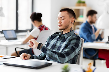 Image showing creative man with smart watch working at office