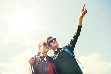 Image showing happy couple with backpacks hiking outdoors