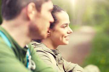 Image showing smiling couple with backpacks in nature